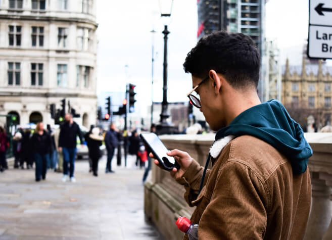 man using app in city