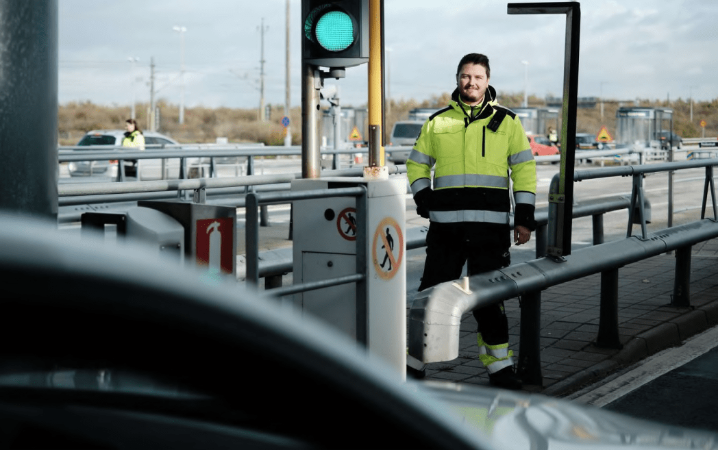 man in hi-viz stood at bridge gate